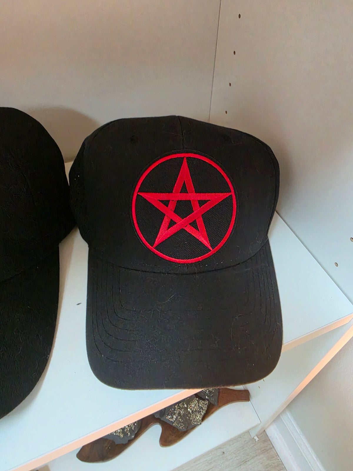 Black baseball cap with red embroidered pentagram design
